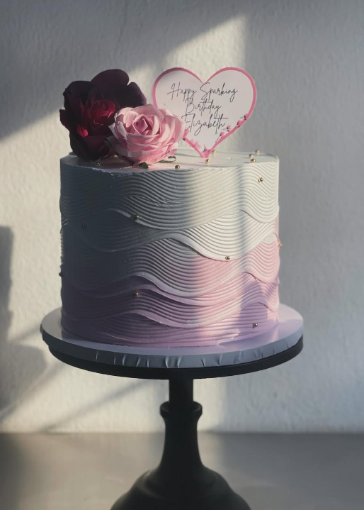 Pink and grey ombre wave-textured celebration cake with fresh roses