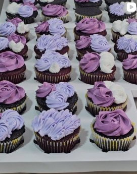 Tray of chocolate cupcakes with purple buttercream swirls