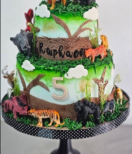 Two-tier jungle safari cake with animal figurines